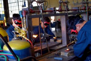 These students are welding 2 pieces of metal together.