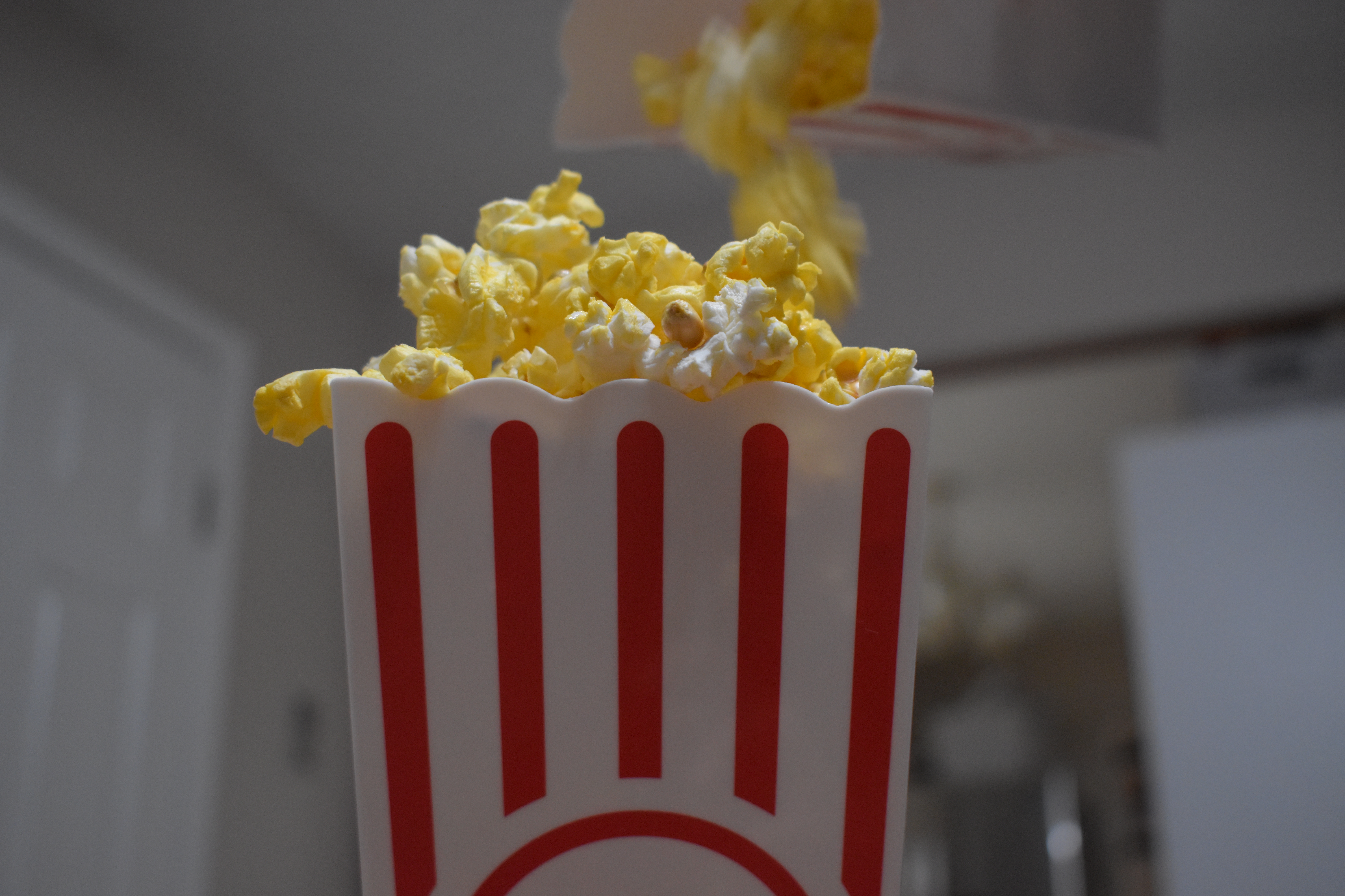 Pouring popcorn into popcorn bucket