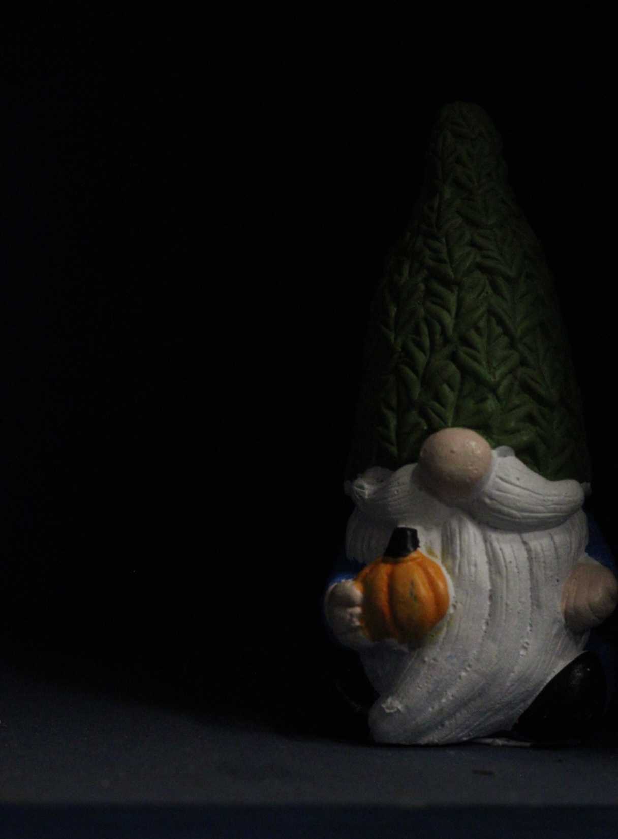 Negative Space; The Gnome in the Newspaper Shelf surrounded by the dark.